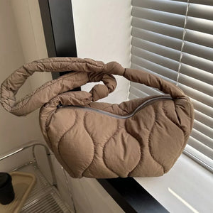 Puffy quilted crossbody bag in brown with knotted strap and abstract pattern.