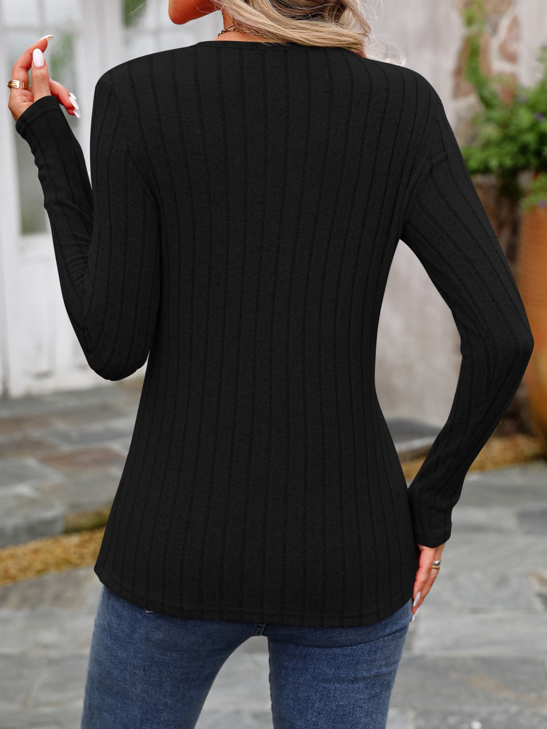 Black ribbed long sleeve top with round neck and button detail