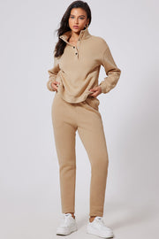 Button-neck lounge set in dust storm beige, featuring a high collar and snap closure on the sweatshirt.