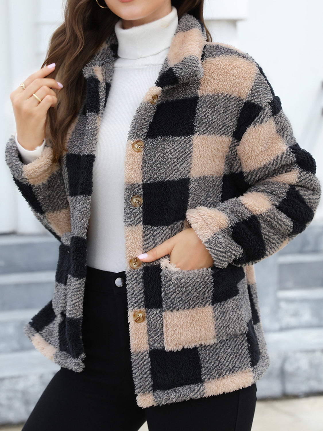 Plaid sherpa overshirt jacket in black and tan with button front and pockets.