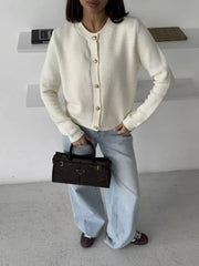 Textured knit cardigan in white with elegant gold button detail and crew neck.