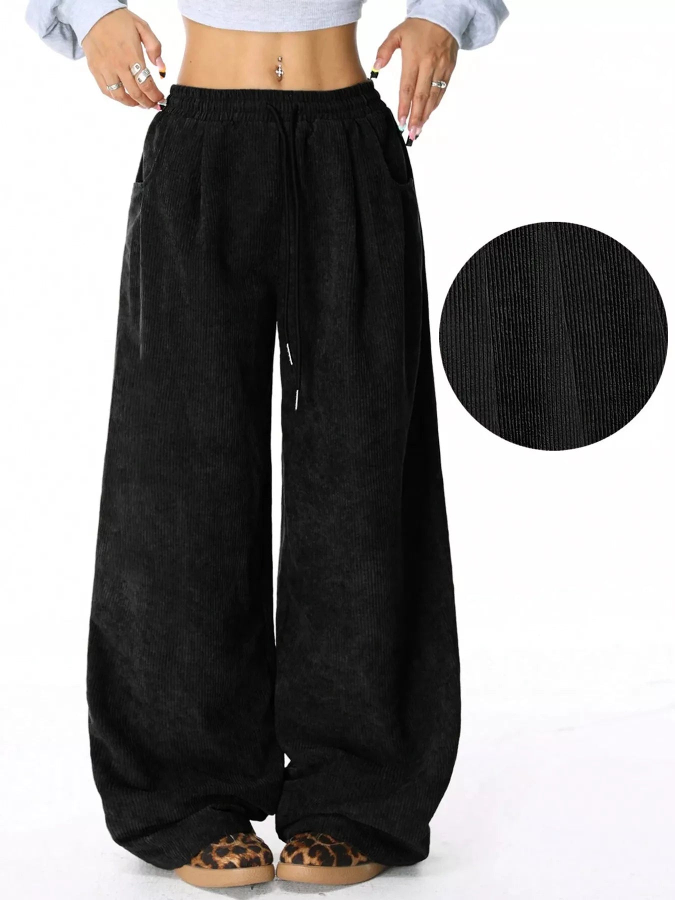 Black corduroy drawstring pants with a relaxed fit and wide leg.