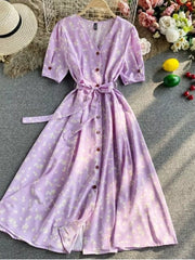 Violet floral V-neck midi dress with short sleeves, button front, and belted waist.