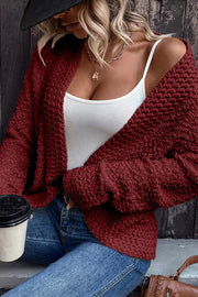 Textured bouclé open-front jacket in burgundy, with a casual open neckline and long sleeves.