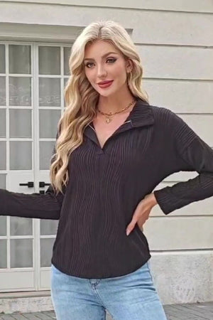 Black pleated wave-effect collared blouse with a V-neck and long sleeves.