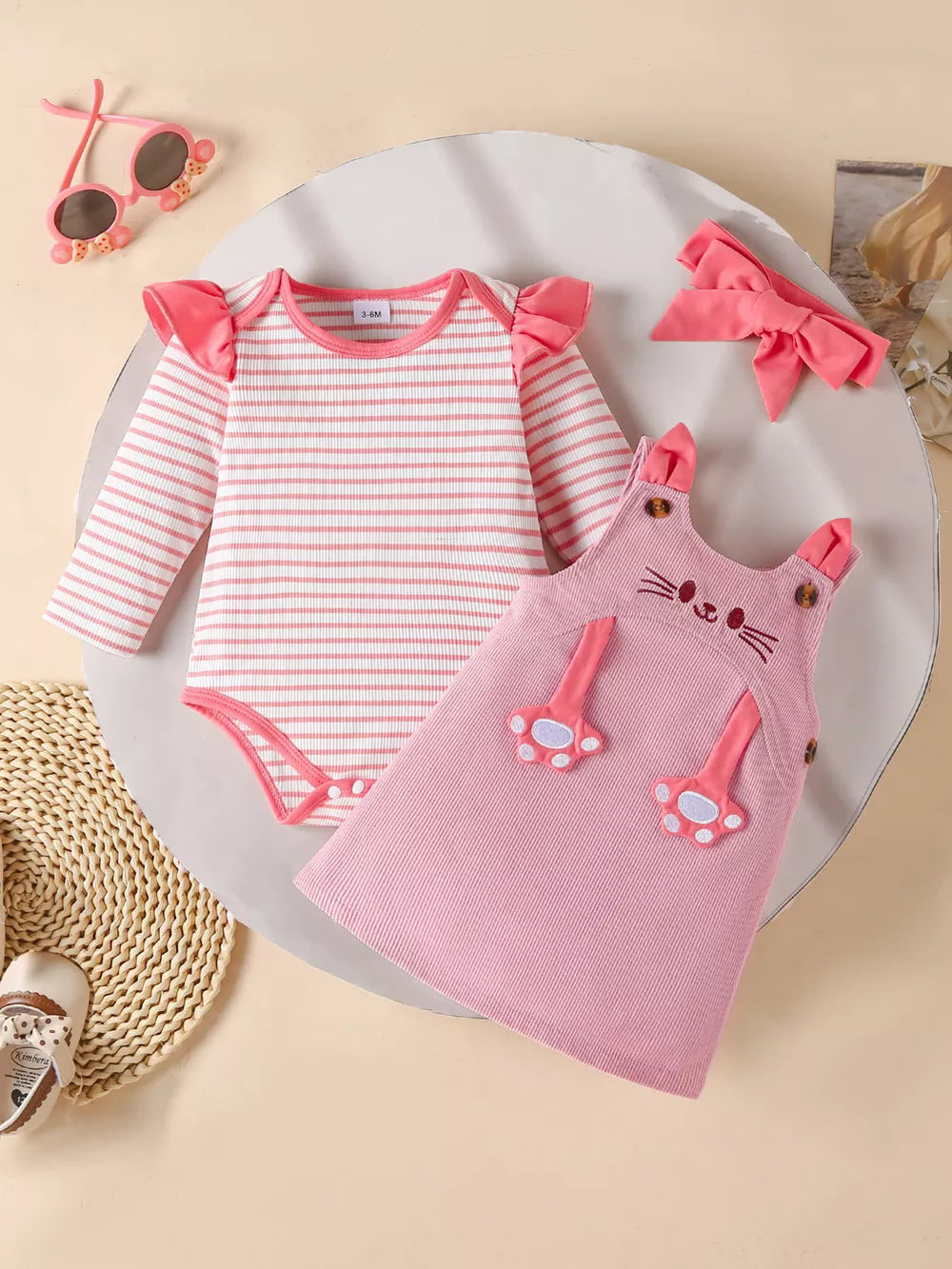 Pink striped long sleeve bodysuit with ruffled sleeves and matching cat-face pinafore dress.
