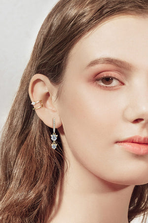 Gold moissanite drop earrings with heart-shaped stones and a matching ear cuff.