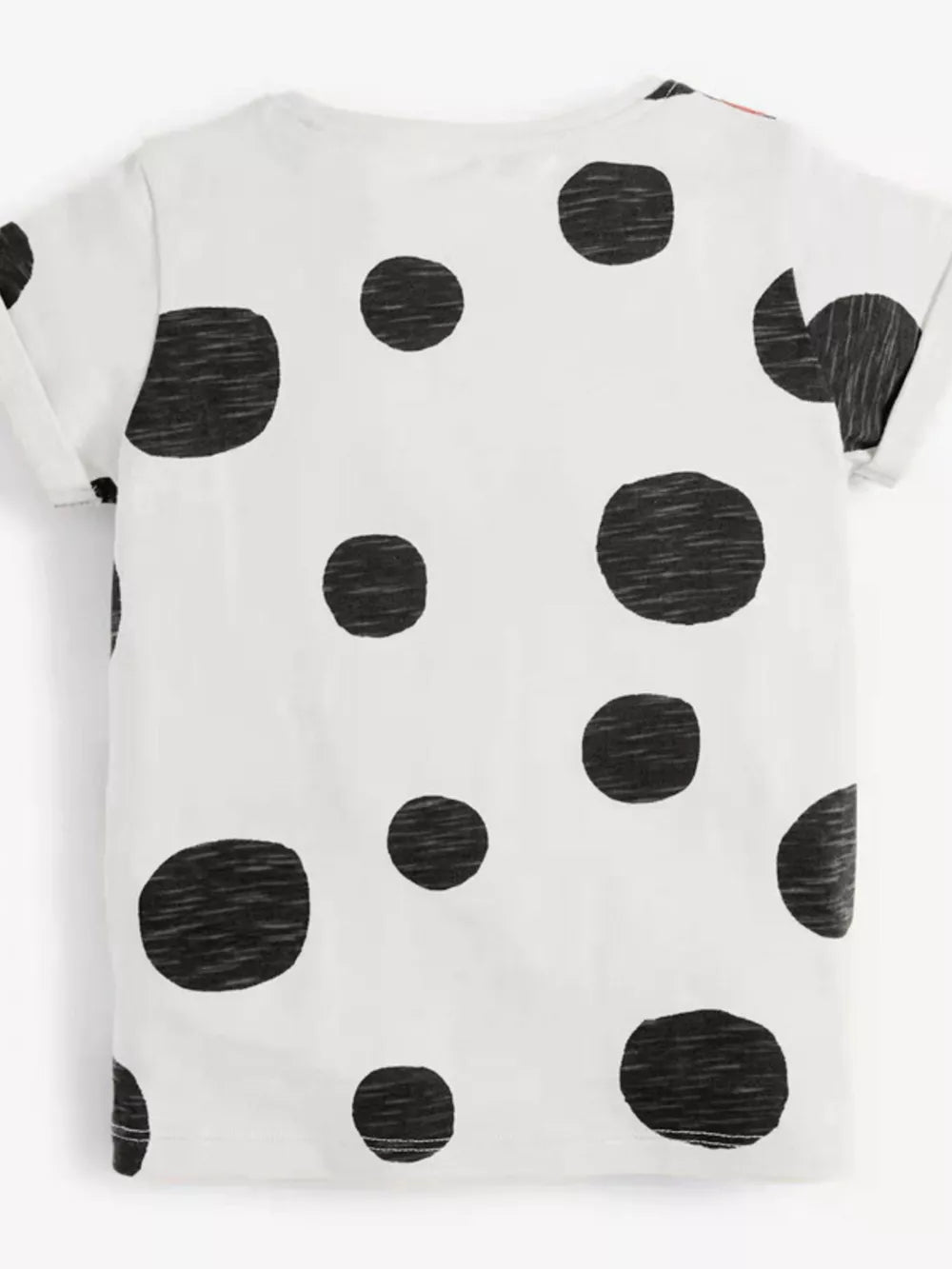 Toddler white cotton t-shirt with black polka dots and rolled sleeves.