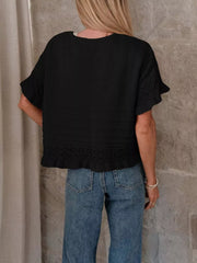 Black knit top with crew neck, short sleeves, and delicate lace trim at cuffs and hem.