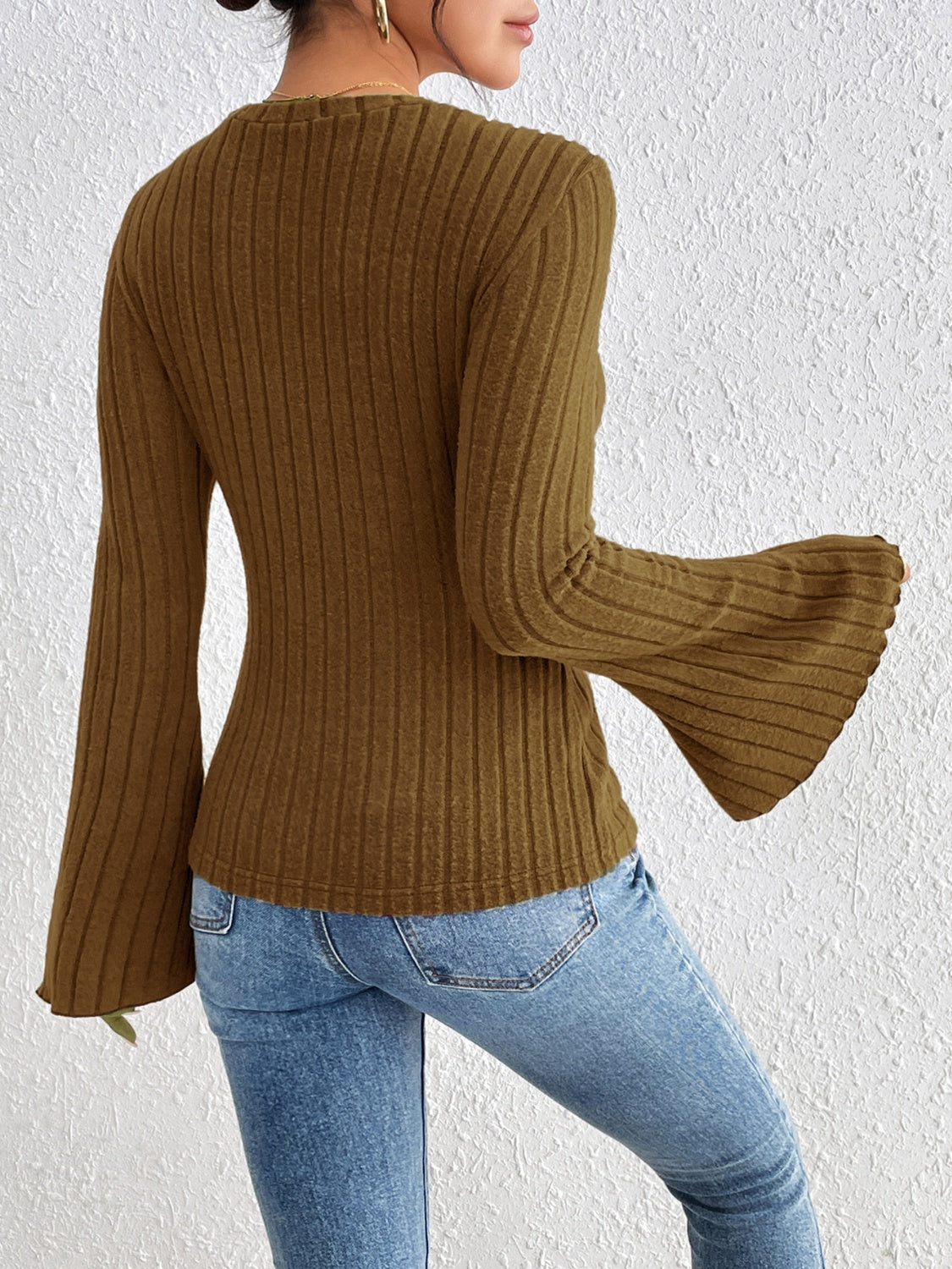 Olive brown ribbed sweater with flared sleeves and a casual fit.