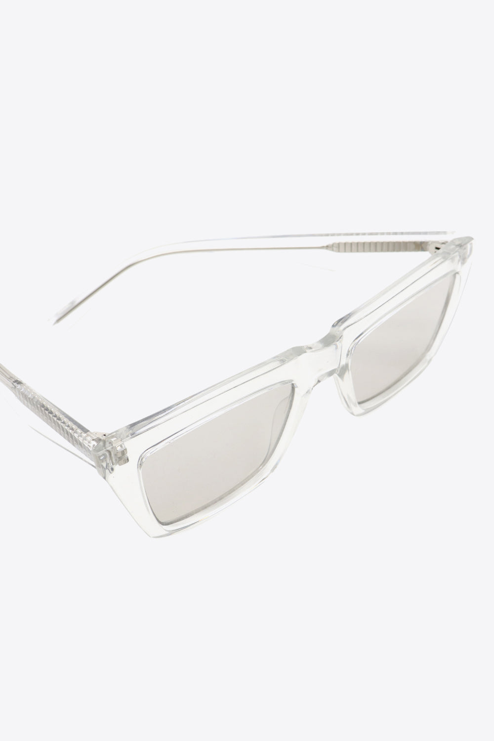 Clear acetate angular sunglasses with light gray lenses and textured temples.