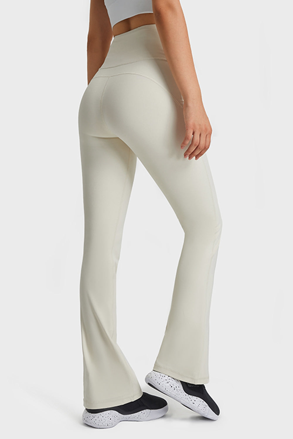 White flare yoga pants with high waist and breathable fabric.