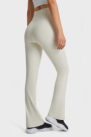 White flare yoga pants with high waist and breathable fabric.