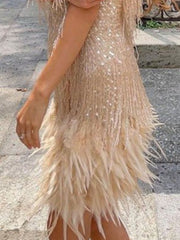 Beige mini dress with fringe, sequins, and feather trim.
