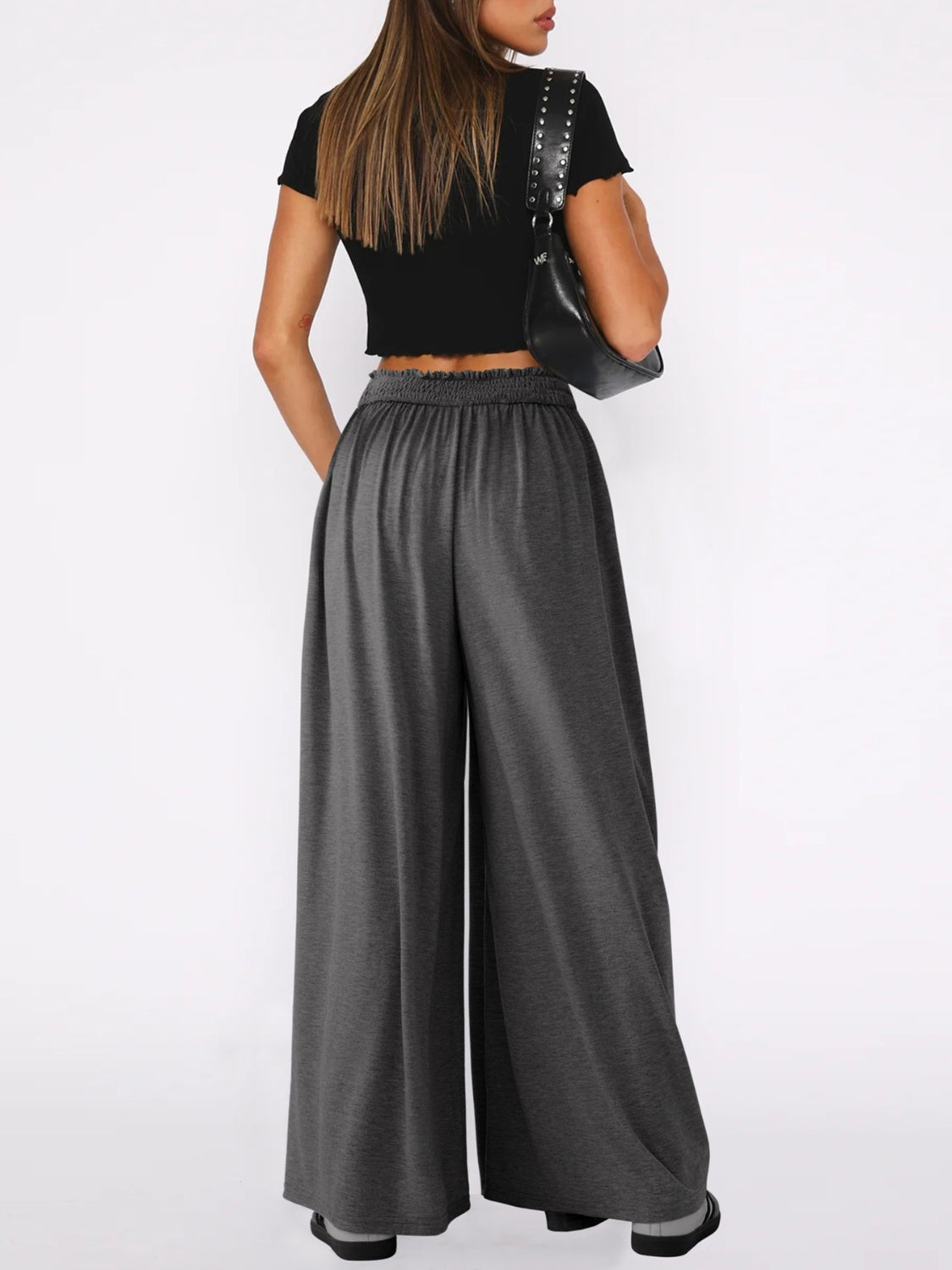 Drape-front wide-leg jersey trousers in dark gray with elastic waistband.