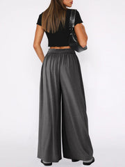 Drape-front wide-leg jersey trousers in dark gray with elastic waistband.