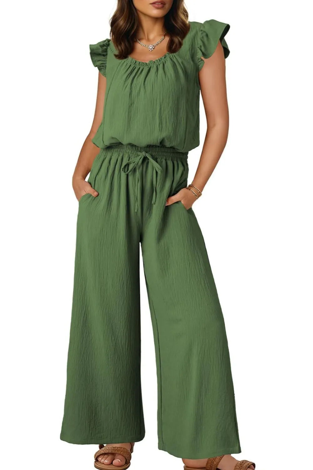 Matcha green textured drawstring palazzo jumpsuit with ruffle sleeves and pockets.