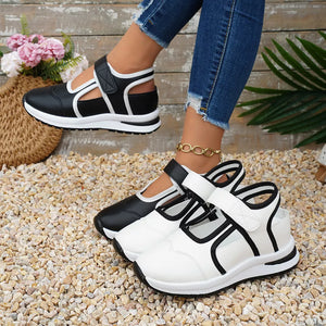 Black and white contrast cutout Mary Jane sneakers with adjustable straps.