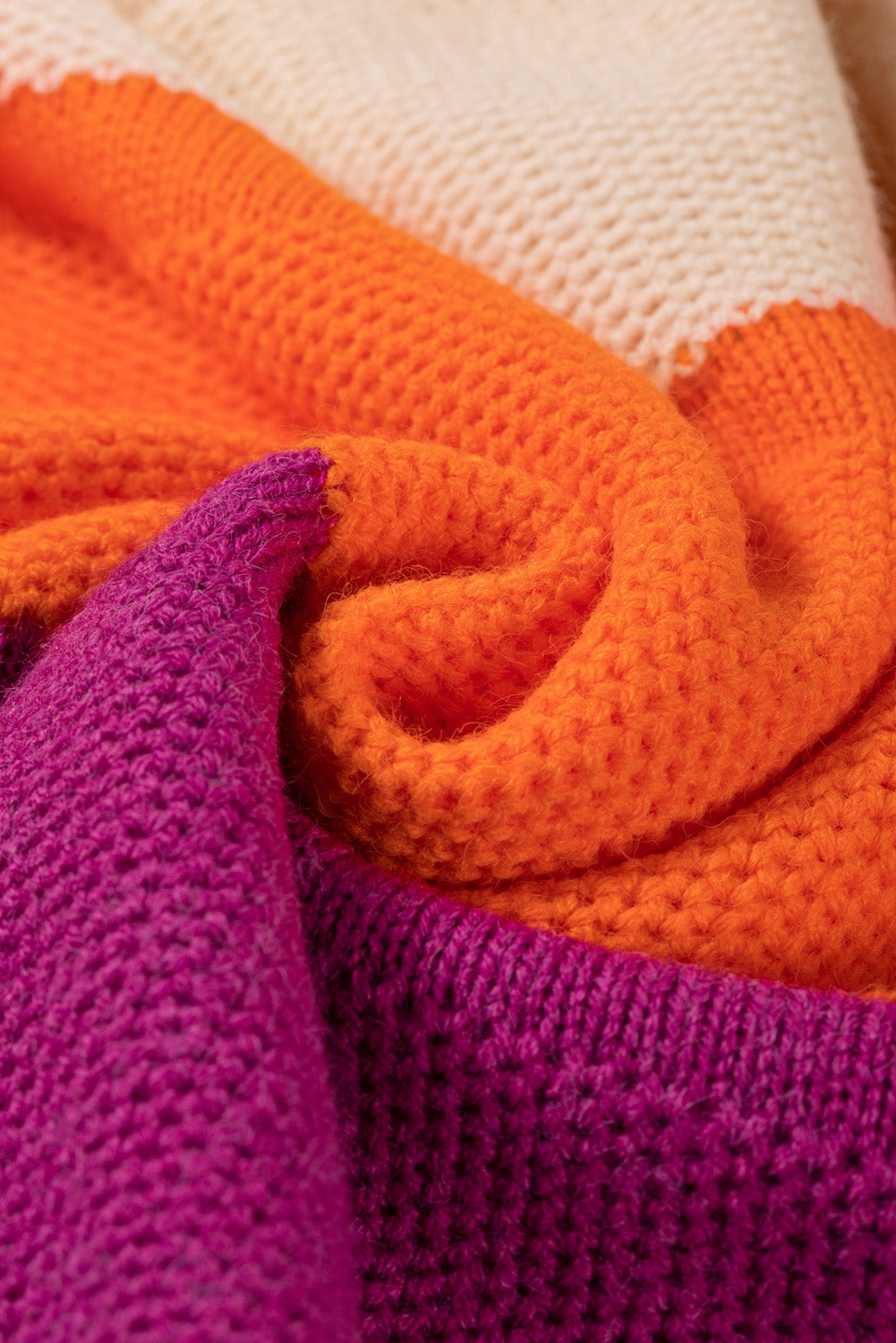 Colorblock ribbed knit pullover sweater in orange, cream, and magenta acrylic.