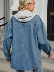 Oversized denim trucker jacket with grey hood, buttoned front, and curved hem.
