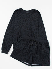 Dark gray leopard print pajama set with crew neck sweatshirt and drawstring shorts.
