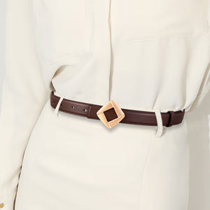 Brown leather belt with a geometric gold buckle