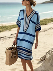 Striped blue midi dress with V-neck and half sleeves, perfect for the beach.