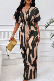 Abstract brushstroke wide-leg jumpsuit in black and taupe with V-neck and short sleeves.