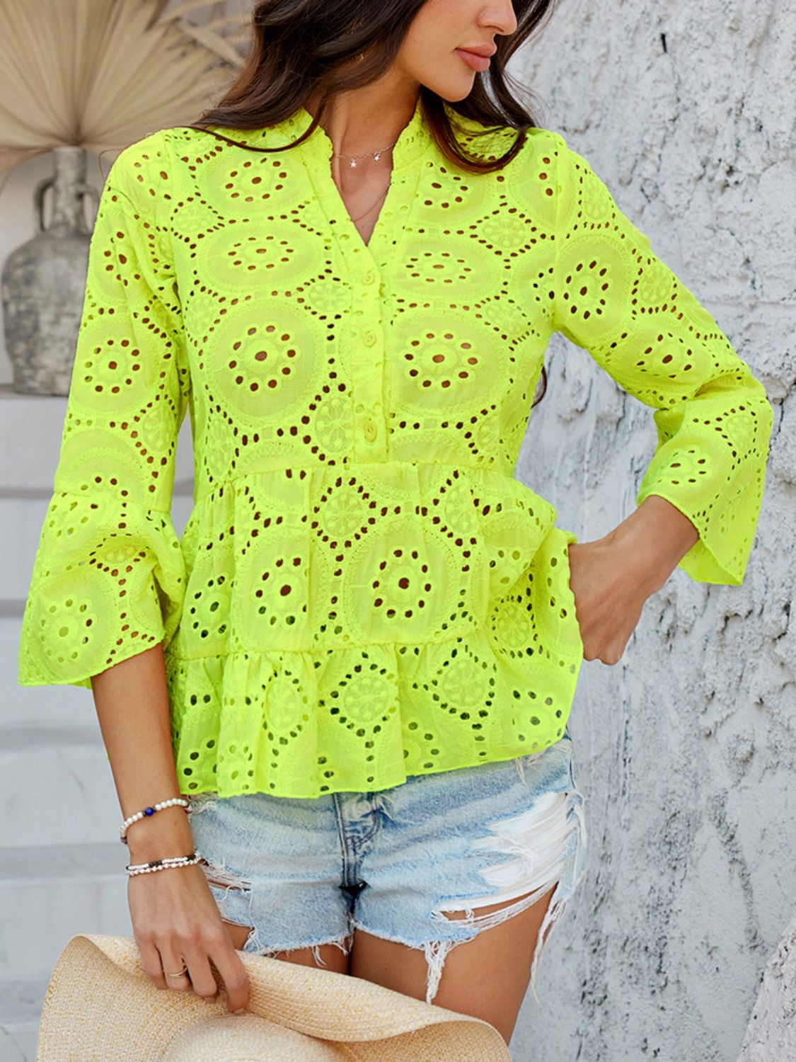 Neon yellow eyelet embroidered peplum blouse with ruffles and bell sleeves.