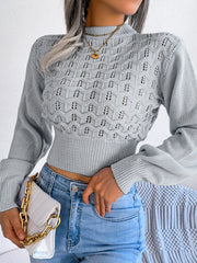 Light gray openwork puff sleeve knit sweater with mock neck and ribbed hem.