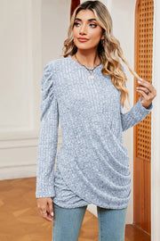 Light blue textured blouse with ruched drape detail and puff sleeves