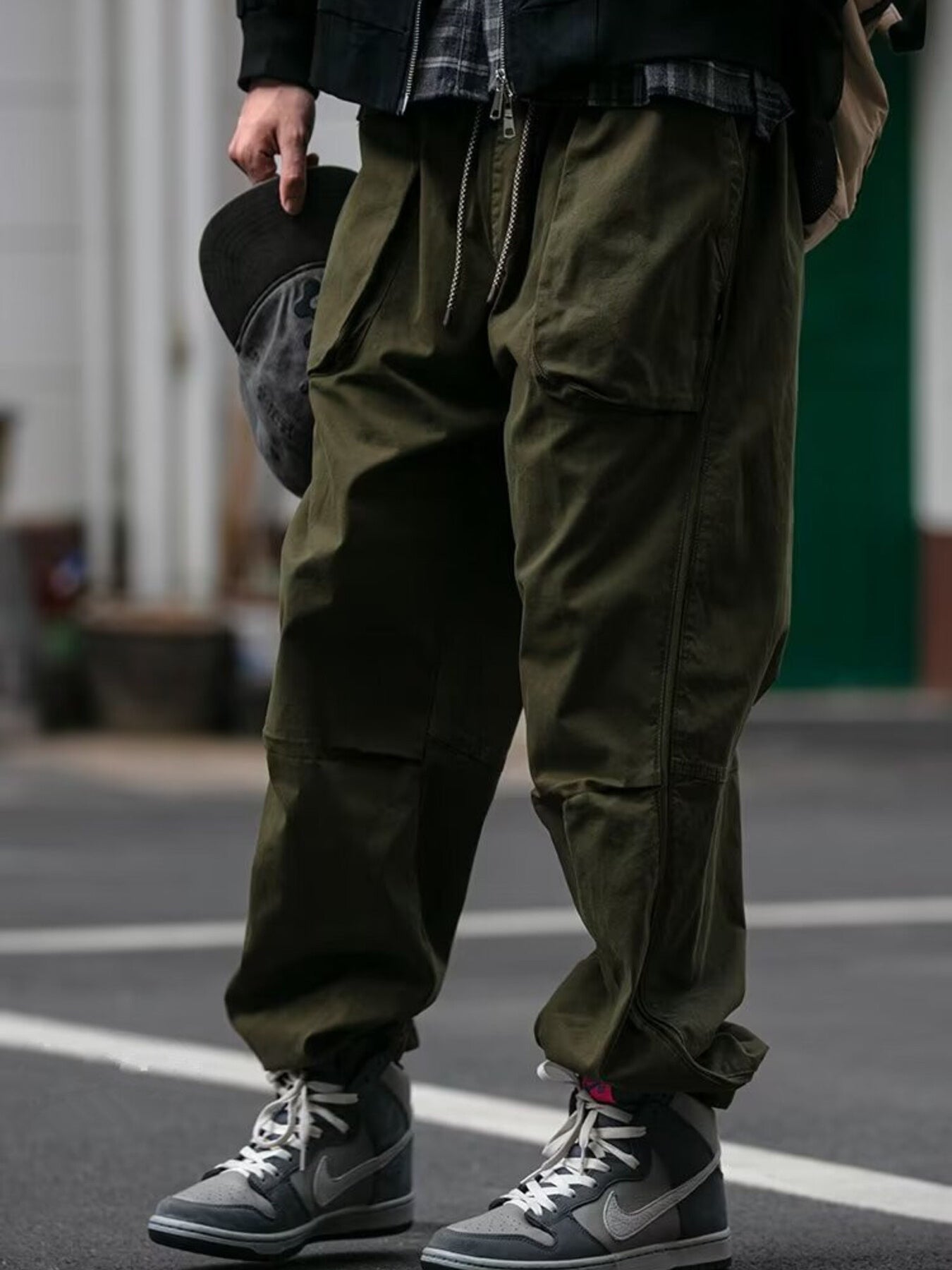 Men's army green drawstring sweatpants with multiple pockets and a relaxed fit.