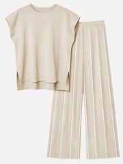 Beige seamed knit co-ord set with a cap-sleeve top and wide-leg pants.