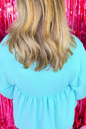 Mint blue textured babydoll blouse with smocked waist and puff sleeves.