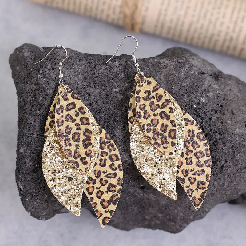 Leopard print layered drop earrings with glitter accents in gold.