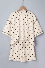 Cream polka dot polyester two-piece set with drawstring shorts and crew neck top.