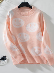 Watermelon pink intarsia knit sweater with allover white smiley faces, crewneck, long sleeves.