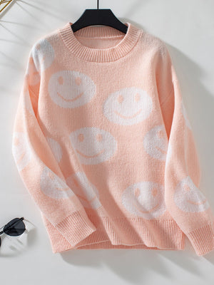 Watermelon pink intarsia knit sweater with allover white smiley faces, crewneck, long sleeves.