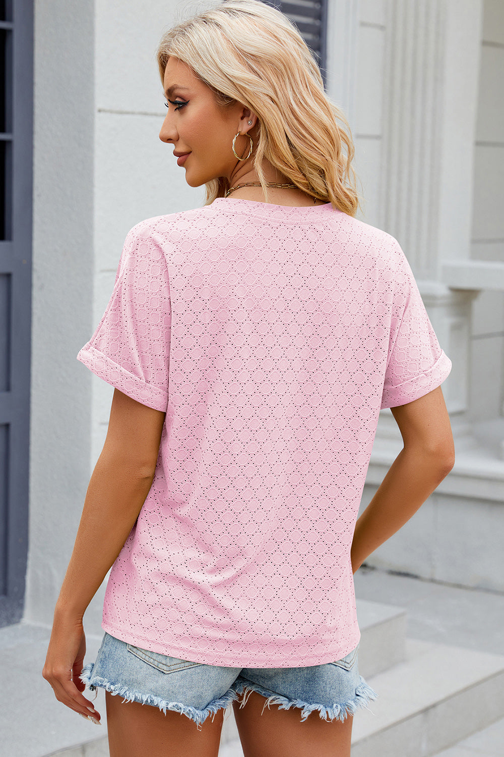 Textured blush pink henley tee with rolled sleeves and diamond eyelet pattern