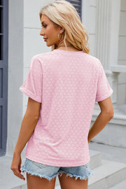 Textured blush pink henley tee with rolled sleeves and diamond eyelet pattern