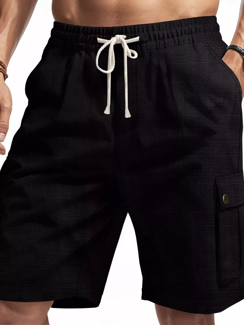 Black cargo shorts for men with drawstring waist and textured fabric.