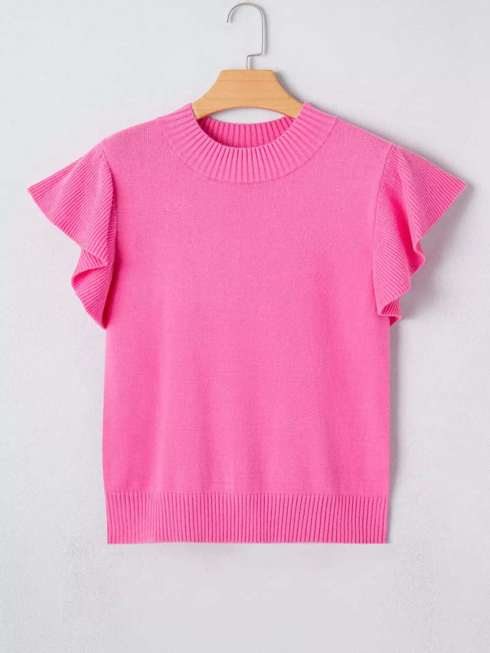 Pink knit top with ruffled short sleeves and ribbed mock neckline.
