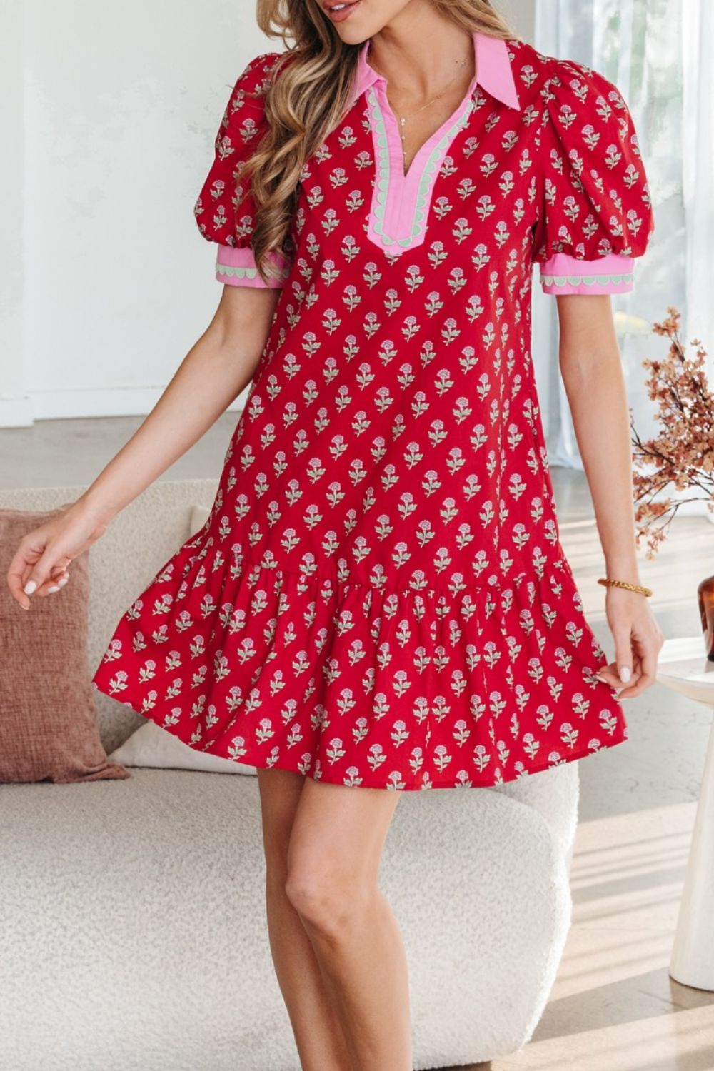 Red floral mini dress with puff sleeves, ruffled hem, and contrast collar.