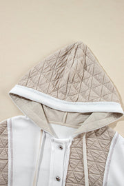 Hoodie with quilted panels and waffle knit fabric, featuring a drawstring hood and button closure.