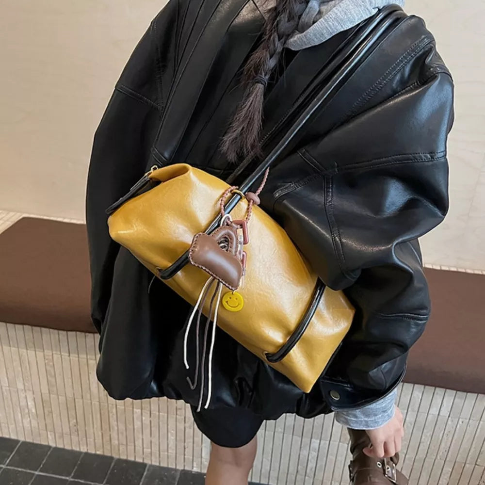 Yellow pu leather shoulder bag with heart charm and smiley face detail