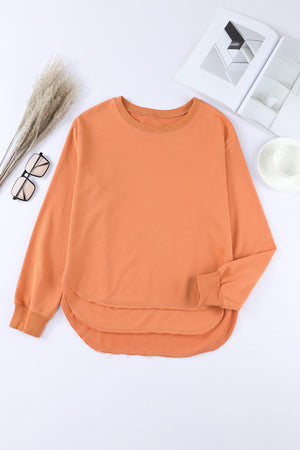 Orange sweatshirt with asymmetric hemline and crew neck