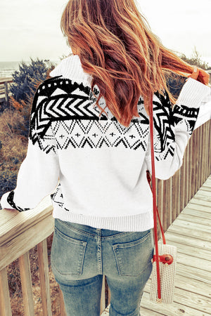 White knit pullover with black geometric pattern and zip neck.