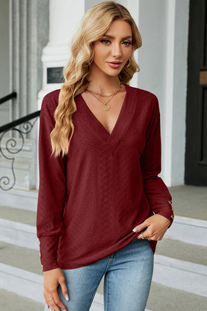 Burgundy V-neck blouse with diamond texture and button cuffs