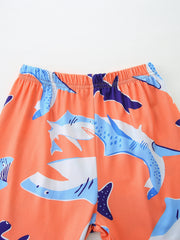 Boys' lightweight shorts with playful shark print on orange background