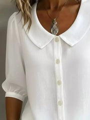 White button-down shirt with Peter Pan collar and puff sleeves.